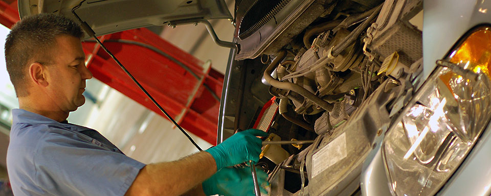 Image showing VEMA repair technician working with the hood open on a VEMA managed vehicle